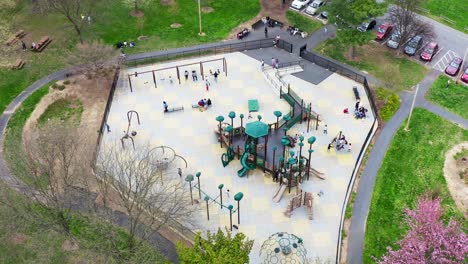 Children-and-families-play-on-playground-equipment-at-community-public-park