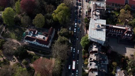 Overhead-aerial-drone-shot-of-traffic-on-north-london-street-highgate-hill