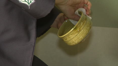 Tea-bowl-is-ritualistically-wiped-dry-during-a-Japanese-tea-ceremony-