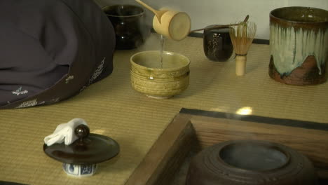 Hot-water-is-ladled-from-tetsubin-kettle-during-a-Japanese-tea-ceremony-