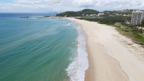 White-Sand-Of-Palm-Beach-Seashore-With-A-View-Of-Currumbin-Point-In-Australian-State-Of-Queensland