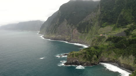 Drone-aerial-footage-flying-along-North-coast-of-Madeira-towards-Véu-da-Noiva-waterfall-in-Portugal