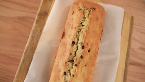 Top-View-of-Freshly-Baked-Chocolate-Chip-Loaf,-Spin-on-Wooden-Background
