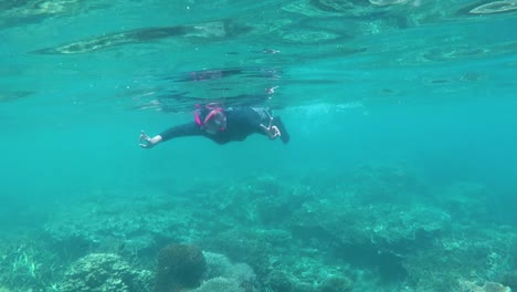 Happy-woman-snorkeling-and-playing-underwater-with-fish-at-Karimun-Jawa