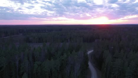 Red-bright-sunset-over-conifer-forest-in-aerial-drone-view