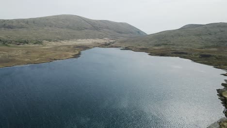 Tilt-down-aerial-view-of-Spelga-Reservoir-and-Mourne-Mountains