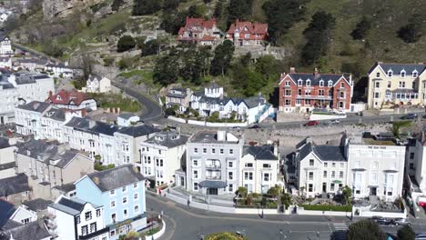 Colourful-Llandudno-seaside-holiday-town-hotels-against-Great-Orme-mountain-aerial-view-right-orbit