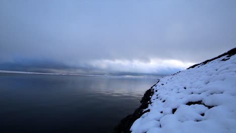 Beautiful-shot-of-gaddins-dam-in-todmorden-,-covered-in-snow-in-a-very-peaceful-calming-shot