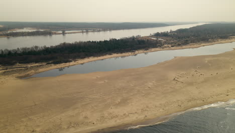 Ascending-aerial-shot-of-beautiful-landscape-with-Vistula-River-Mouth-surrounded-by-Nature-Reserve-with-Lake-and-Sand-Bank
