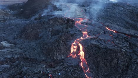Tourist-watching-viscous-lava-stream-at-Fagradalsfjall-volcano-in-Iceland