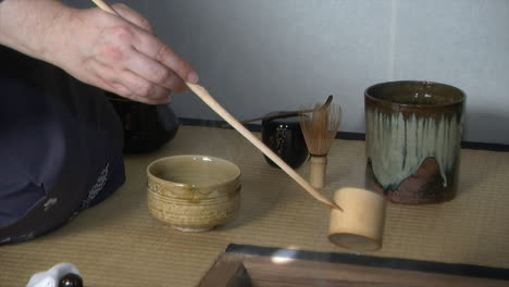 Hot-water-is-added-to-tea-bowl-and-whisked-during-a-Japanese-tea-ceremony-
