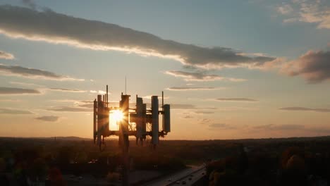 Aerial-cellphone-technology-5G,-4G-tower-at-sunrise,-sunset