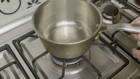 Gas-cooker-ignition-and-placing-pot-on-it
