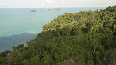 Aerial-fly-over-tropical-jungle-with-ocean-and-tropical-islands-in-distance