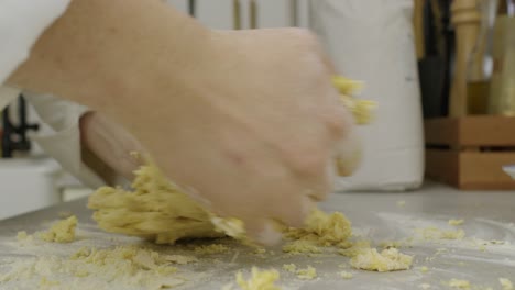 Kneeing-pasta-dough-on-cooking-kitchen-table