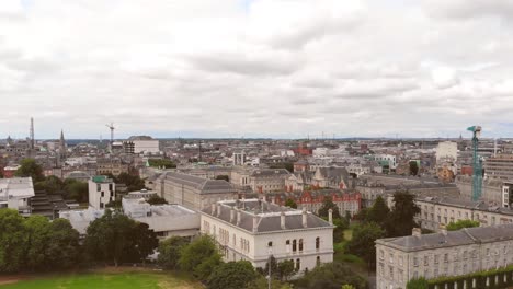 Crane-up-over-Dublin-wide-Cityscape-on-a-cloudy-day,-Ireland---Aerial