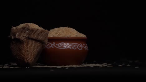 White-rice-in-bowl-and-a-bag,-Isolated-in-a-black-background