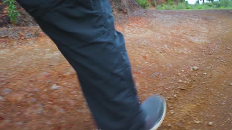 Men's-feet-and-legs-walking-on-the-forest