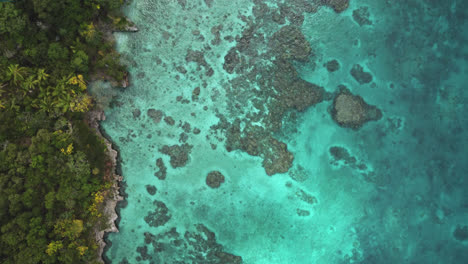 New-Caledonia-tropical-island-of-Lifou,-4K-aerial-top-down-of-turquoise-seascape