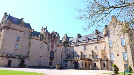 Rear-view-of-Fyvie-castle-with-lady-walking-across-the-courtyard