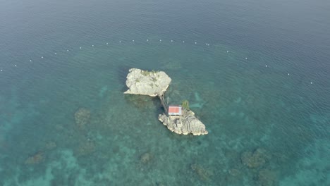 Cottage-On-A-Rock-Surrounded-By-Clear-Blue-Sea-In-Tranquil-Island-In-The-Philippines