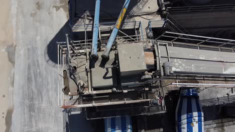Medium-overhead-aerial-view-of-a-concrete-mixing-plant-as-the-concrete-is-moved-to-the-mixer