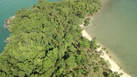 Aerial-ascending-shot-looking-down-on-tropical-island-beach,-jungle-and-rocky-coastline