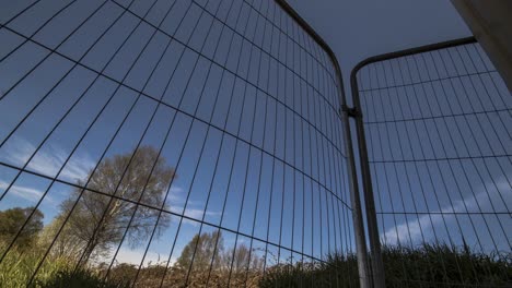 time-lapse-of-clouds-passing-through-a-construction-fence