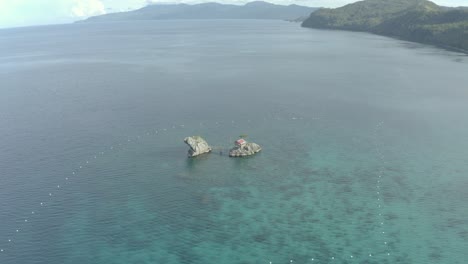 Cottage-On-Limestone-Rock-Formation-Surrounded-With-Calm-Blue-Water-Of-Ocean-In-Tropical-Island-Of-Philippines
