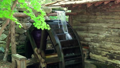 Water-flow-on-Water-Wheel-as-a-part-of-Korean-traditional-Watermill-In-A-Zen-Garden-At-A-Korean-Folk-Village-in-Yongin,-South-Korea