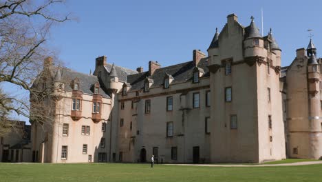 Walker-passes-in-front-of-the-side-elevation-of-Fyvie-castle-on-a-lovely-spring-morning