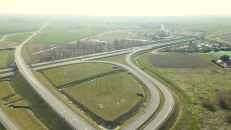 Down-aerial-over-highway-during-sunny-day,-Poland-s7-road-on-Pomerania