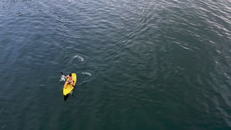 Half-Naked-Man-Kayaking-On-Serene-Ocean-On-San-Pablo-Island,-Southern-Leyte,-Hinunangan,-Philippines