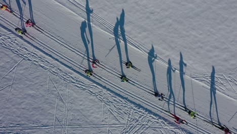 Aerial-top-down-of-Race-between-athletes-skiers-in-the-mountains