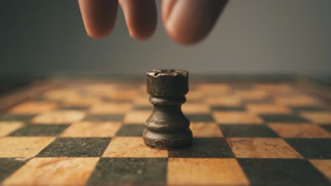 Close-up-shot-of-rook-chess-piece-being-placed-on-game-board