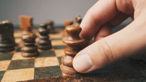 White-queen-move-chessboard-male-hand