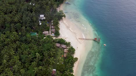 Flying-Towards-Scenic-Island-With-Palm-Forest-And-Cottages-At-Summer-In-San-Pablo-Island,-Southern-Leyte,-Philippines