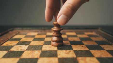 White-queen-chessboard-male-hand