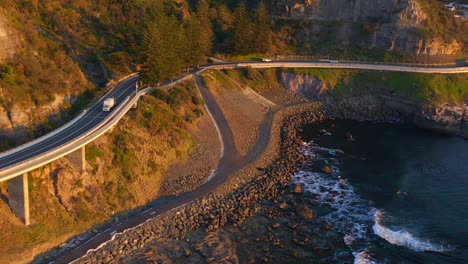 Cars-Drive-By-Steel-Bridge-Of-Sea-Cliff-In-Ilawarra-Coast-and-New-South-Wales-Australia---aerial-shot