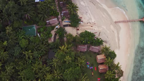Bird's-Eye-View-Of-Palm-Trees-With-Beach-Huts-On-San-Pablo-Island-In-Southern-Leyte,-Philippines