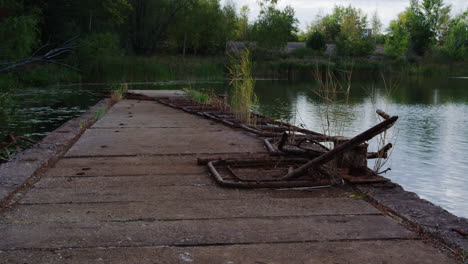 Dolly-in-shot-of-a-rusted-railing-on-a-pier-at-the-Prypiat-river-in-Ukraine