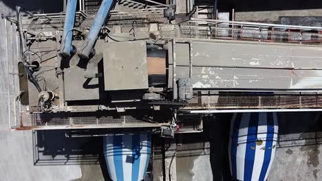 Wide-overhead-aerial-view-of-a-concrete-mixing-plant-as-the-concrete-is-moved-to-the-mixer