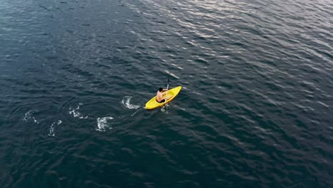 Man-On-Yellow-Canoe-Paddling-On-Blue-Sea-At-Summer-In-Philippines