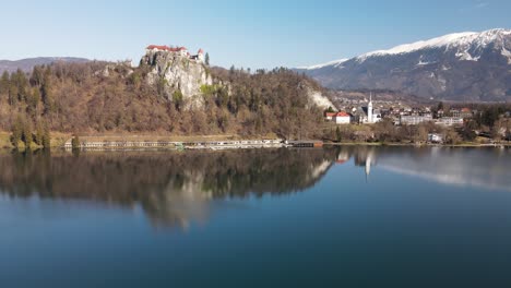 Reflection-of-Bled-Castle,-Blejski-grad,-on-Bled-lake,-Alps,-Slovenia