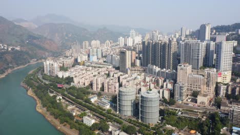 Drone-shot-of-an-industrial-city-located-in-the-valley-of-Sichuan,-China