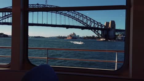 View-Of-Opera-House-From-The-Window-Of-Sailing-Ferry-Boat-During-Summer-In-Sydney,-New-South-Wales,-Australia