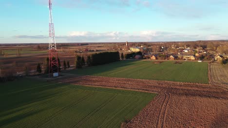Aerial-View-Antenna-Tower-In-The-Countryside-Fields-Near-The-Town