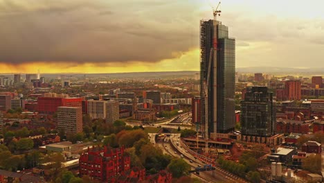 Aerial-drone-pedestal-rising-shot-of-Manchester-city-Beetham-Tower-sunset,-England