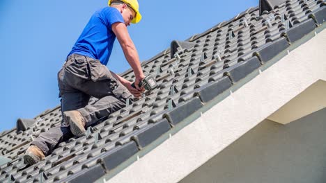 Professional-male-roofer-preparing-roof-tiles-for-solar-panel-construction