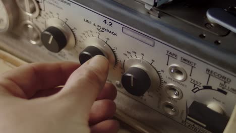 Adjusting-the-volume-on-a-NAGRA-professional-recording-device